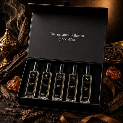 A luxury gift set containing five  glass perfume bottles with black caps, presented in an open black box. The box lid features the gold text 'The Signature Collection by SocialSkn'.
